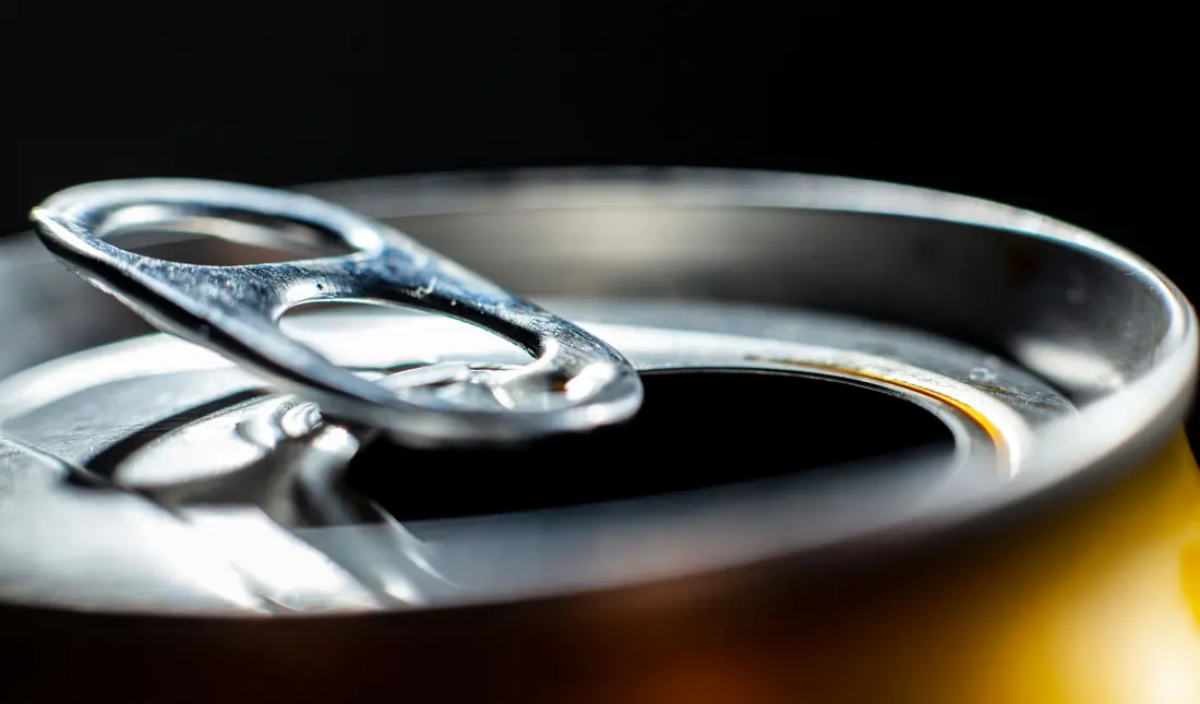 A can that has been opened, the tab pulled back